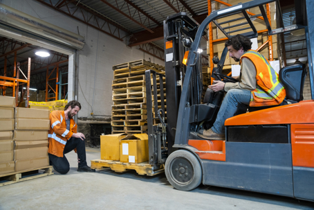 A forklift driver cause serious injury as he lowers his forks onto a coworker's foot